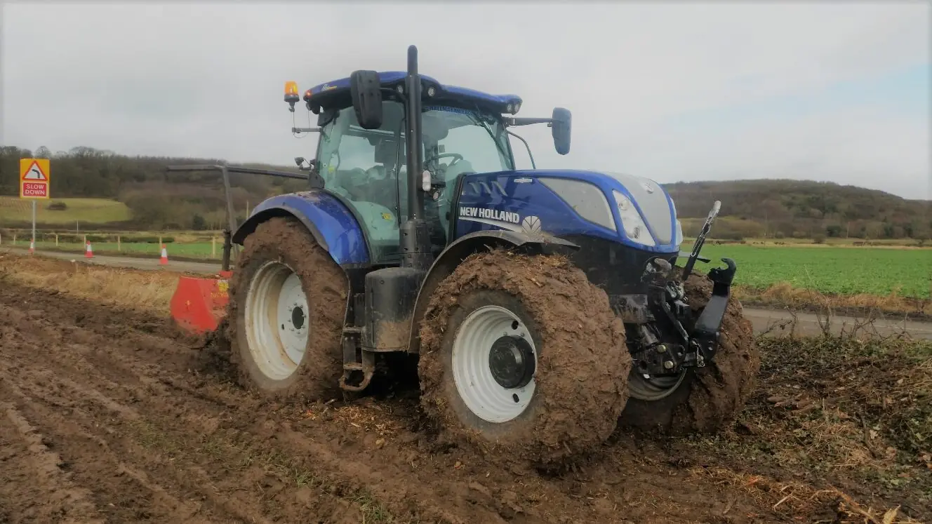 New Holland tractor operating on difficult ground